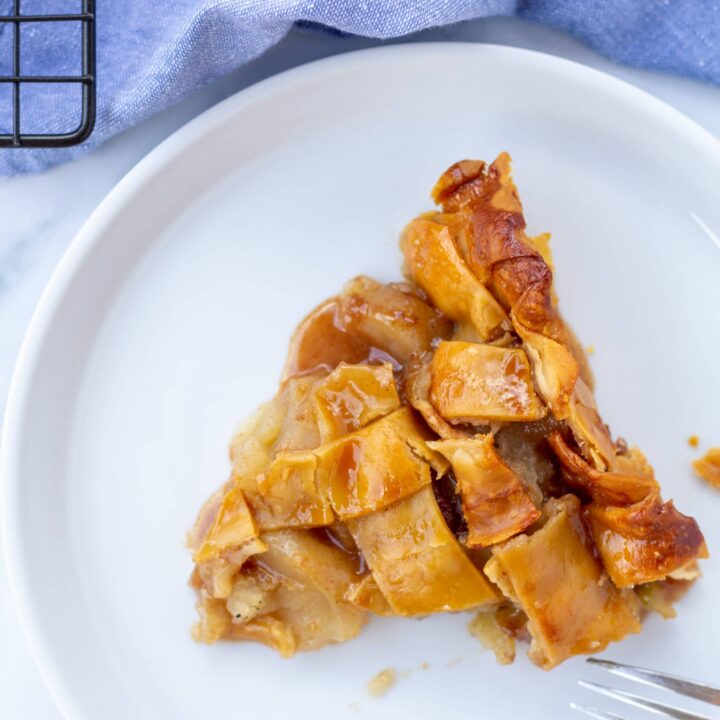 A slice of pie on a white plate over head