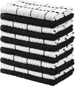 A stack of folded white and black kitchen towels